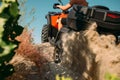 Atv rider climbing the sand mountain, back view Royalty Free Stock Photo