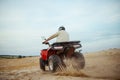 An atv rider racing in desert