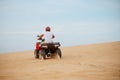 An atv rider racing in desert