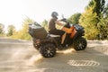 Atv riding in sand quarry, dust clouds, quad bike Royalty Free Stock Photo