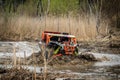 ATV/UTV/4x4 driving throw splashing past a large puddle Royalty Free Stock Photo