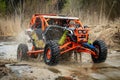 ATV/UTV/4x4 driving throw splashing past a large puddle Royalty Free Stock Photo