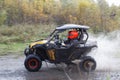 ATV vehicle on a dirt road through the forest.