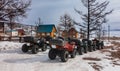 ATVs lined up on the snowy road