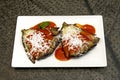 aubergine with grated goat cheese and tomato is a bite that delights