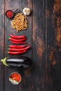 Aubergine penne ingredients eggplant pasta, pepper tomatoe sauce, on old wooden table top view  space for text Royalty Free Stock Photo