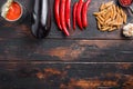 Aubergine penne ingredients eggplant pasta, pepper tomatoe sauce, on old wooden table top view  space for text Royalty Free Stock Photo