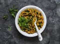 Aubergine spinach vegetarian indian curry on a dark background, top view. Indian cuisine