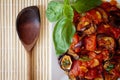 Aubergines in tomato sauce with wooden spoon Royalty Free Stock Photo