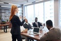 Side view on business lady speaking to international group of people