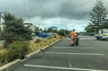 Auckland Council worker carrying black garbage bag