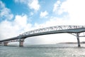 Auckland Harbor Bridge against blue sky in Auckland, New Zealand.