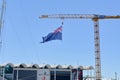 giant New Zealand flag on tower crane, over NZ team base building