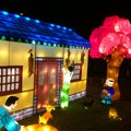 Chinese Lantern festival, family figure light sculpture and tree and house. Royalty Free Stock Photo