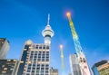 AUCKLAND, NEW ZEALAND - MARCH 25, 2018; Brightly illuminated towers for Sky Screamer and Sky Towers at night in city downtown