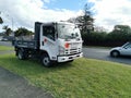 AUCKLAND, NEW ZEALAND - Sep 24, 2020: View of Sunset Concrete Isuzu N Series truck packed on green lawn