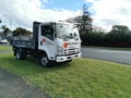 AUCKLAND, NEW ZEALAND - Sep 24, 2020: View of Sunset Concrete Isuzu N Series truck packed on green lawn