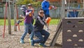 Auckland, New Zealand, 10th of Nov 2019, adults and kids playing nerf gun together at an outdoor children playground