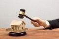 Auction, Real Estate concept. Hand with judge gavel and house model Royalty Free Stock Photo