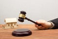 Auction, Real Estate concept. Hand with judge gavel and house model Royalty Free Stock Photo