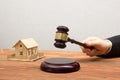 Auction, Real Estate concept. Hand with judge gavel and house model Royalty Free Stock Photo