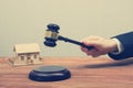 Auction, Real Estate concept. Hand with judge gavel and house model Royalty Free Stock Photo