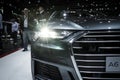 Audi A6 headlight and visitors at the Paris Motor Show. France - October 3, 2018