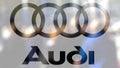 Audi logo on a glass against blurred crowd on the steet. Editorial 3D rendering