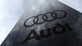 Audi logo on a skyscraper facade reflecting clouds. Editorial 3D rendering