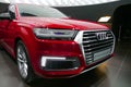 WOLFSBURG, GERMANY - March 22, 2019: Audi Q7 e-tron quattro closeup frontside with lights on and logo in showroom Autostadt Royalty Free Stock Photo