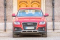 Audi red luxury crossover at the wooden gate door. Russia, Saint-Petersburg. 08. April 2018. Royalty Free Stock Photo