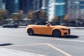 Audi TTS roadster car moving on the street. Orange vehicle driving along city street with blurred background