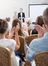 Audience applauding professor after lecture Royalty Free Stock Photo