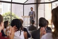 Audience applauding speaker at a business seminar