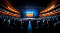 Audience attending a performance in a modern auditorium with stage lights Royalty Free Stock Photo