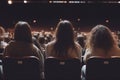Audience at the cinema. Rear view of unrecognizable people sitting in auditorium and watching movie. Back view with Generative AI. Royalty Free Stock Photo