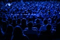 The audience in the cinema, the view from the back. Group of people at the business conference, back view, blue tones.