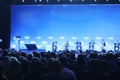 Rear view of Audience over the speakers on the stage in the conference hall or seminar meeting, business and education Royalty Free Stock Photo