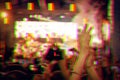 Audience with hands raised at a music festival and lights streaming down from above the stage. Digital signal glitch effect rgb s Royalty Free Stock Photo