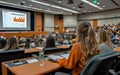 Audience listening to a presentation in a large lecture hall