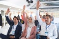 Audience raising their hands in a business conference Royalty Free Stock Photo