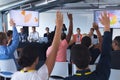 Audience raising their hands in a business conference Royalty Free Stock Photo