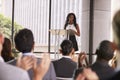 Audience at seminar applauding young black woman at lectern Royalty Free Stock Photo