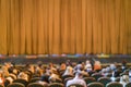 Audience in Theater. closed stage curtain in a theater. blurry