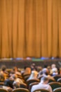 Audience in Theater. closed stage curtain in a theater. blurry. vertical photo