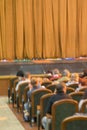 Audience in Theater. closed stage curtain in a theater. blurry. vertical photo