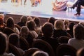 The audience in the theater watching a play. The audience in the hall: adults and children Royalty Free Stock Photo