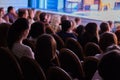 The audience in the theater watching a play. The audience in the hall: adults and children Royalty Free Stock Photo