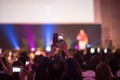 Audience using smart phone technology for take a photo and There is speaker standing in front of the room at the conference hall,