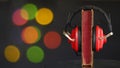 audio book concept with book and vintage headphones,multicolored bokeh balls in the background